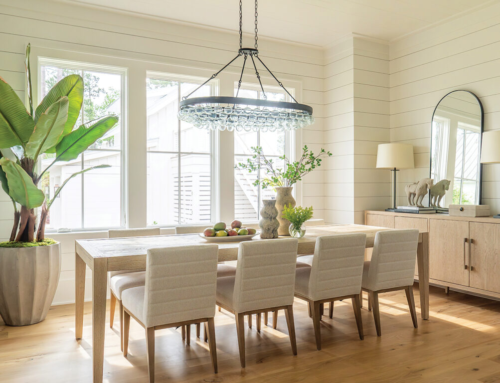 A neutral toned dining room with shiplap walls