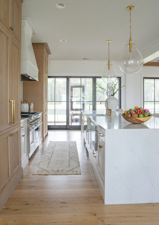 Waterfall island and two-toned cabinetry in the kitchen