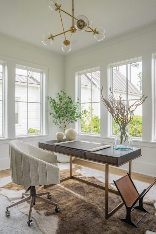 An office with a minimalist desk and chair and animal skin rug