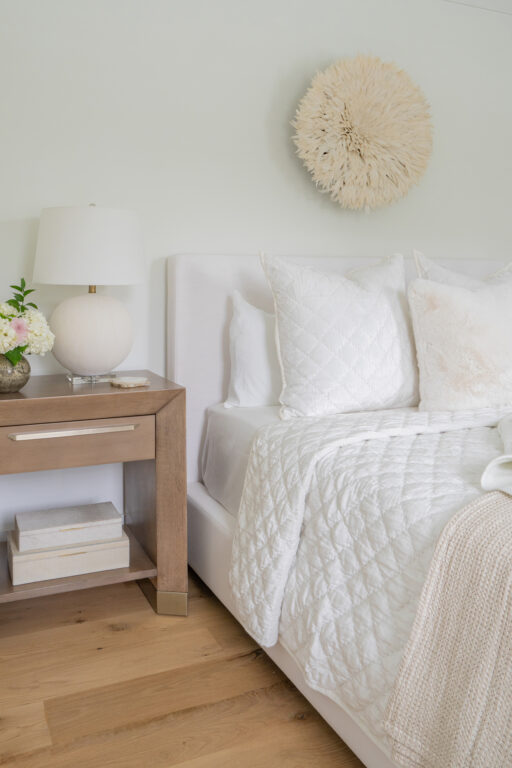 A neutral toned bedroom with white bedding