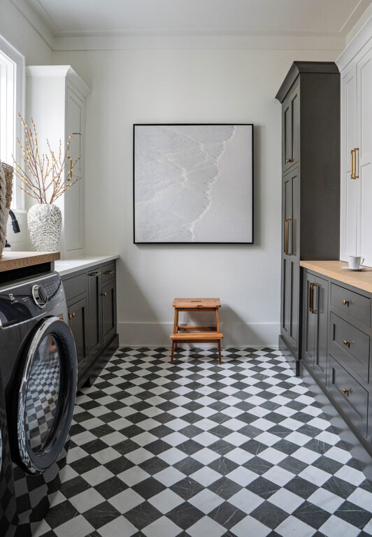 A black-and-white checkered tile floor in the laundry room