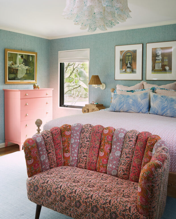 Wicker urn pedestals and a midcentury Venetian blown-glass petal chandelier in a primary bedroom