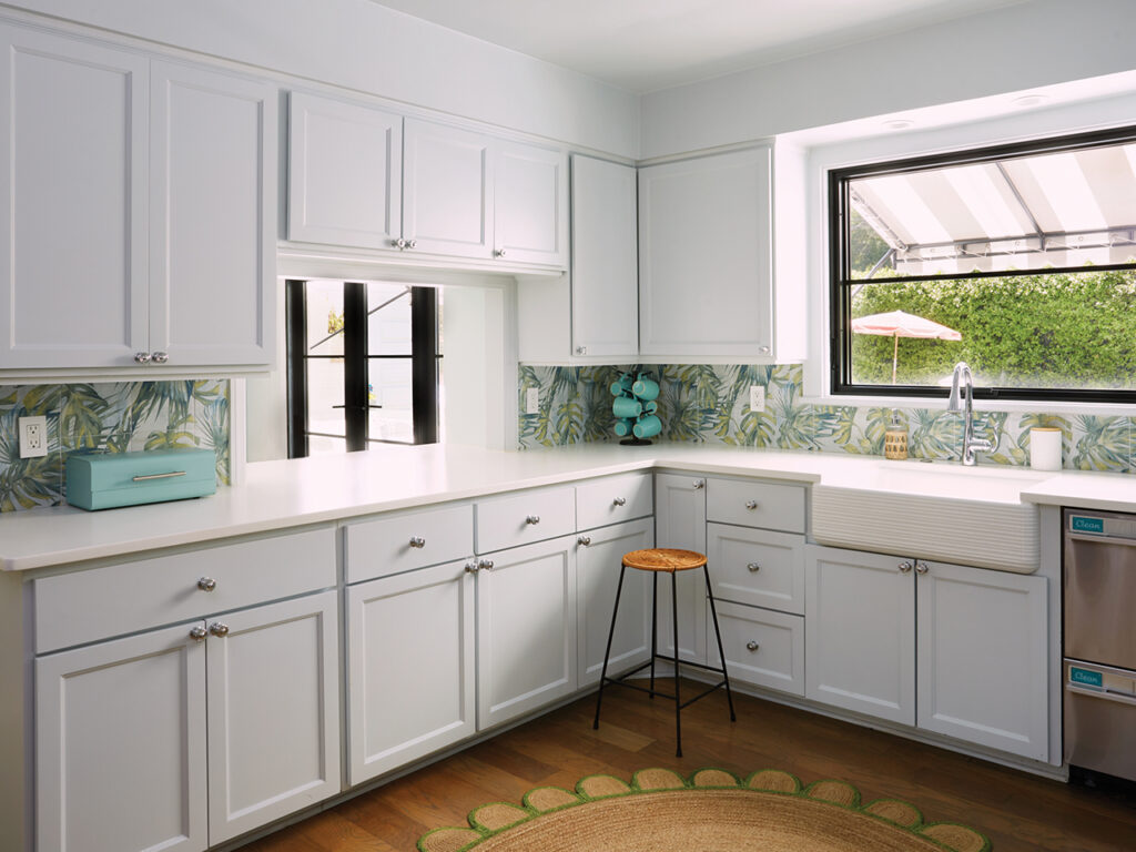 A kitchen with light blue cabinets