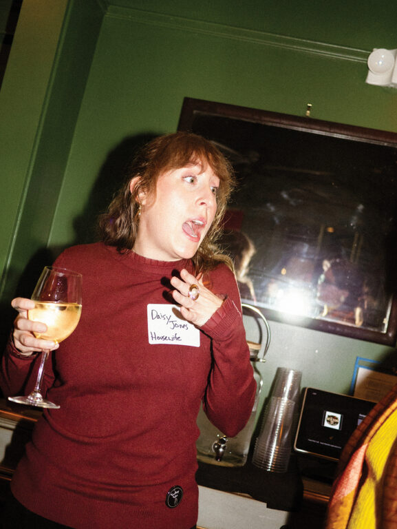 murder mystery character holding a glass of wine and gasping