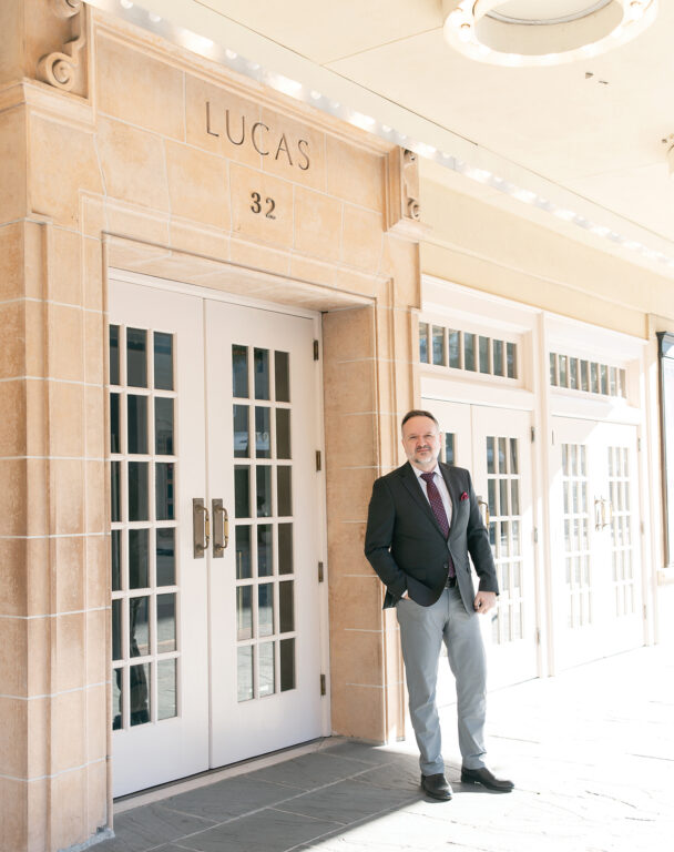 Sinisa Ciric stands in front of the entrance to the Lucas Theatre