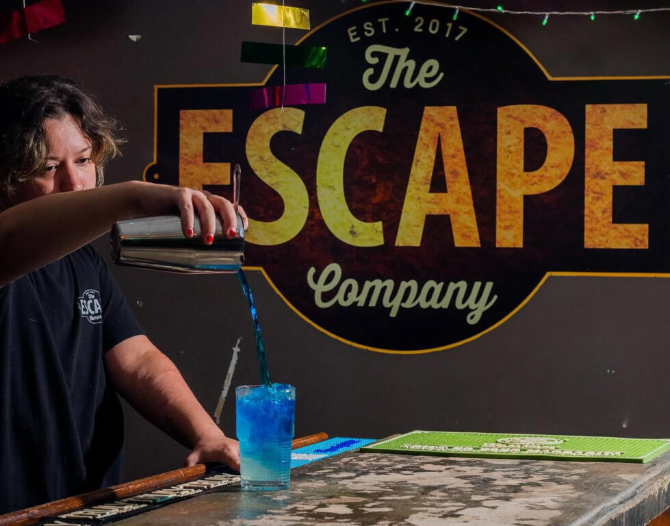 Bartender pouring a blue cocktail