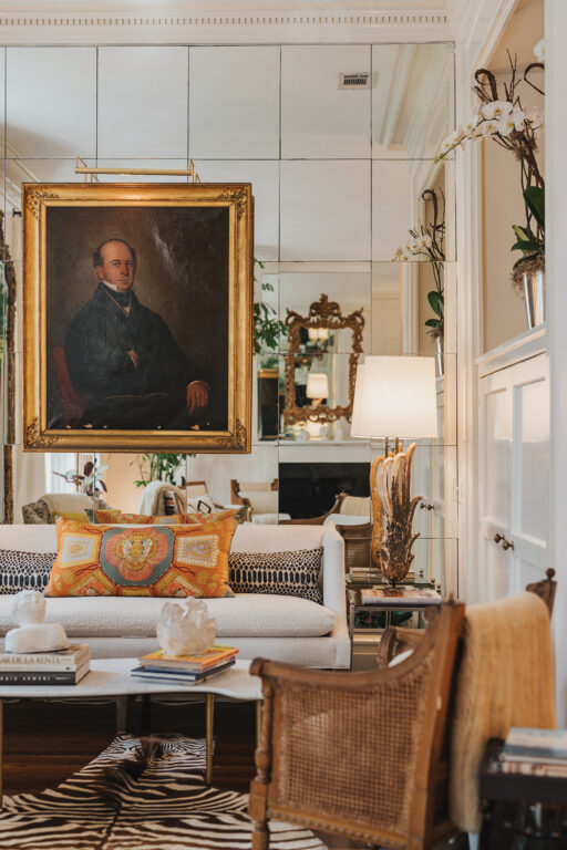 The living room with floor-to-ceiling mirrors and original dental moulding