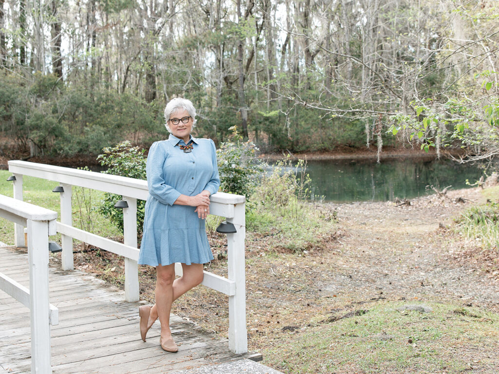 Trish Lawrence standing by a pond at Savannah Botanical Gardens