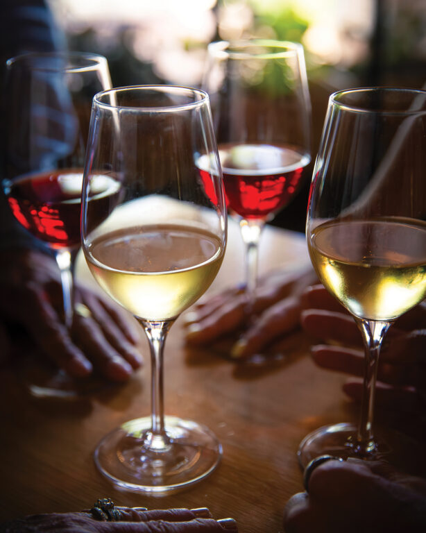 Wine glasses of wine grouped together on a table