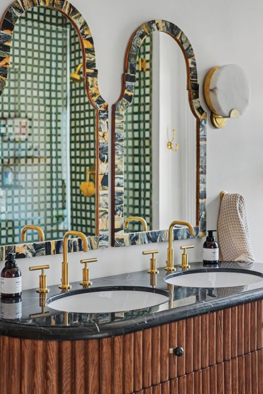 bathroom with white walls, green-and-white checkered zellige tile, and Moroccan mirrors
