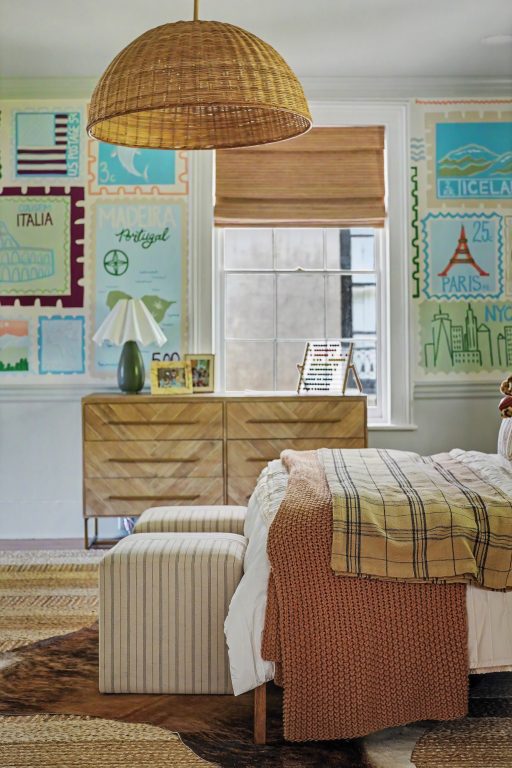 A boy's room with hand-painted mural depicting international postage stamps