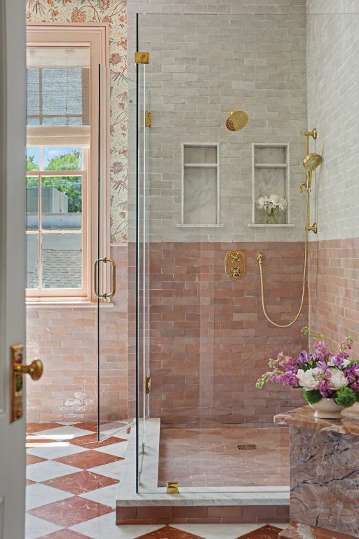 bathroom with floral Ralph Lauren wallpaper, dusty rose-and-white diamond-patterned floor tiles, and pink-and-white rectangular zellige wall tiles