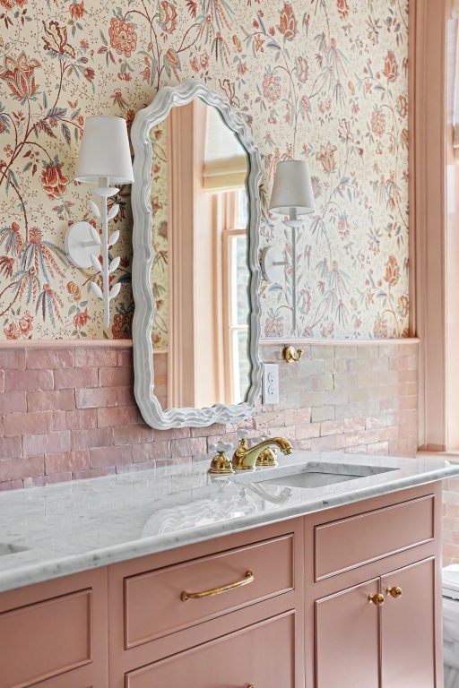 bathroom with floral Ralph Lauren wallpaper and dusty rose vanity