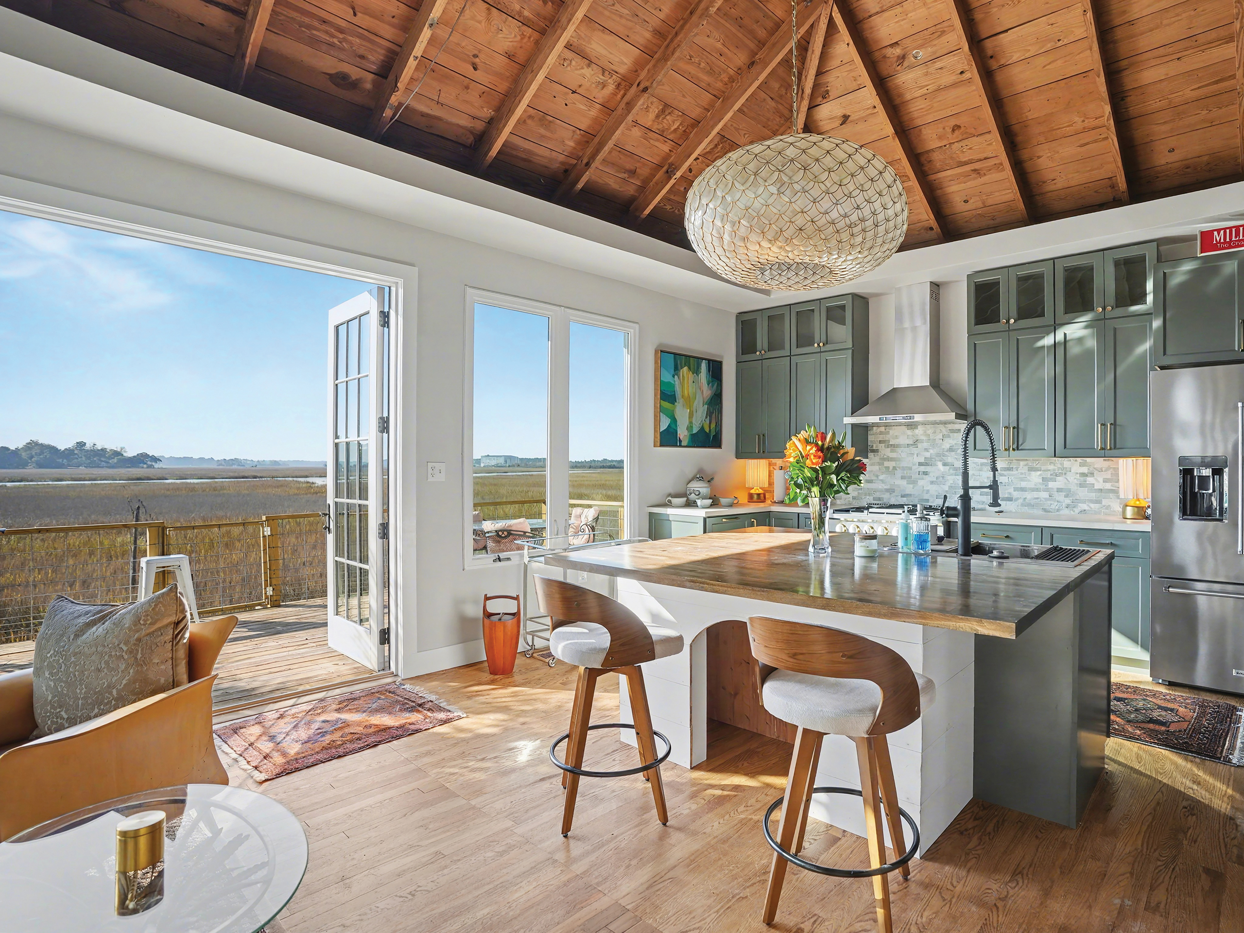 Open concept kitchen and living room with views of the marsh